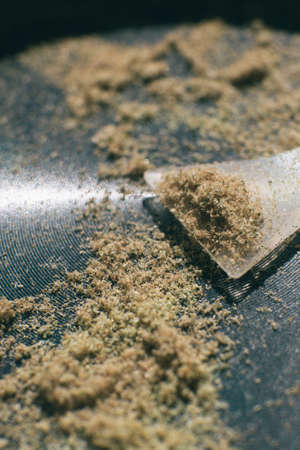 Kief macro in grinder. Sativa medical health. Close up vertical shot. Marijuana Indica THC CBD.の写真素材