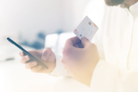 Payment online shopping smartphone at working place. Closeup of young man making Web shopping. Man's...