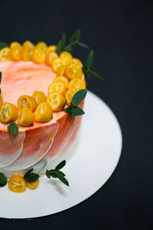 cake with cream on a dark wood background. Fresh delicious birthday cake with candles on table against black background Birthday cake.の写真素材