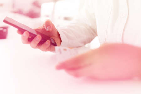 smartphone and holding credit card with social Online payment, Online shopping concept in morning light. credit card and Businessman hands using using smart phone for online shopping.の写真素材