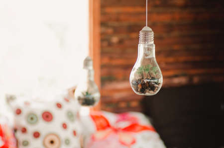 Hanging light bulbs for decoration with rocks insideの写真素材