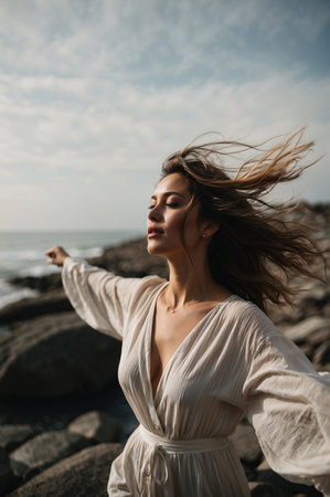 Sunset Serenity: Carefree Young Woman Enjoying the Ocean Breeze on the Beachの素材