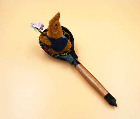 Toy rooster and a flowerの写真素材