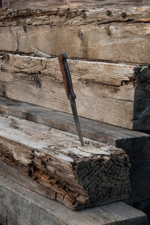 The knife is stuck in the treated woodの写真素材
