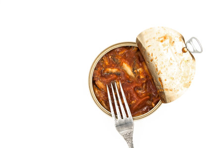 Canned fish in tomato sauce on white background
