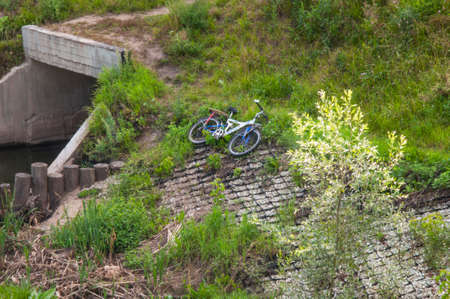 the bike lies on the grass in the parkの写真素材