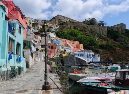 Ancient houses and boats on the island of Procida, Italian town of 10 434 inhabitants in the metropolitan city of Naples in Campania, August 2018, Italyのeditorial素材