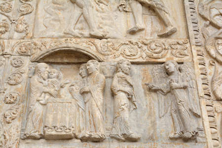 Ancient stone sculptures on the front facade of the cathedral of San Zeno, Verona Italy, August 2019のeditorial素材