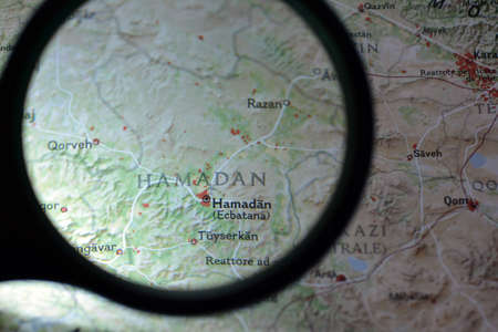 Close-up view with magnifying glass of the Chinese regions on an ancient map, photo taken in Italy, June 2020のeditorial素材