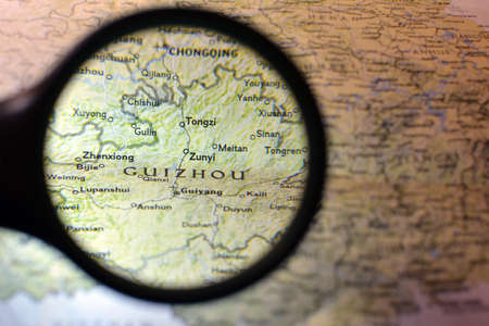 Close-up view with magnifying glass of the Chinese regions on an ancient map, photo taken in Italy, June 2020のeditorial素材