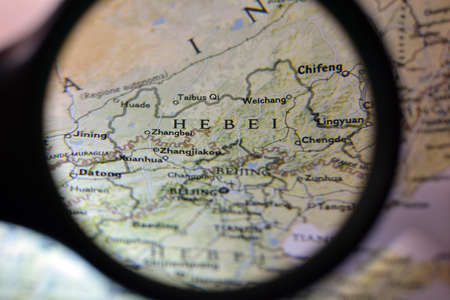 Close-up view with magnifying glass of the Chinese regions on an ancient map, photo taken in Italy, June 2020のeditorial素材