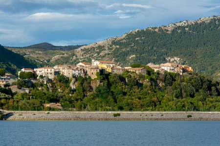 Small ancient village in central Italy, Castel San Vincenzo, with the lake in the light of sunset, Italyの写真素材