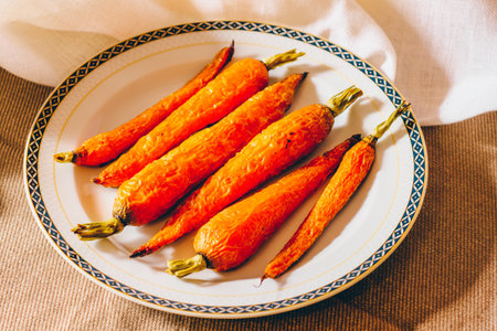 Baked carrots in a plate on the table. Healthy food.の写真素材