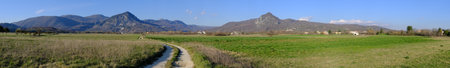Panoramic view of a green meadow with mountains in the background, Rocchetta al Volturno, Molise Italyの写真素材