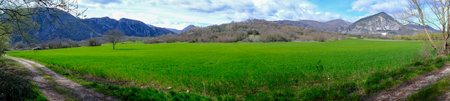Panoramic view of a green field with mountains in the background, Rocchetta al Volturno, Moliseの写真素材