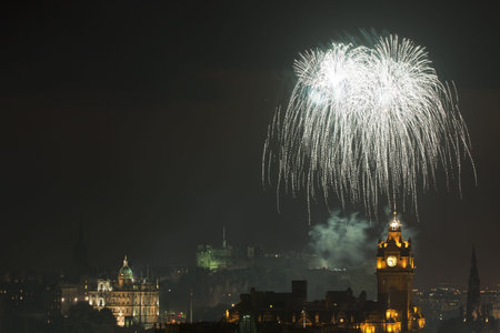 Edinburgh Cityscape with fireworks over The Castle and Balmoral Clock Tower