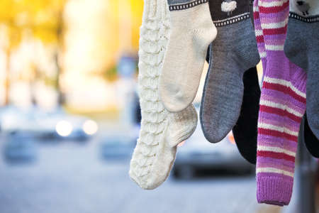 Hanging handmade knit socks with different pattetns with blurry backgroundの写真素材