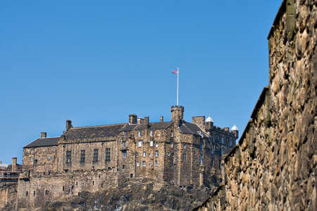 Edinburgh castle with Union Jack against blue skyの写真素材