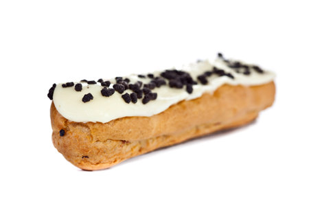 Beautiful fresh baked eclair with vanilla frosting and chocolate chips