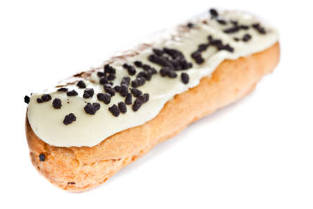 Beautiful fresh baked eclair with vanilla frosting and chocolate chipsの写真素材
