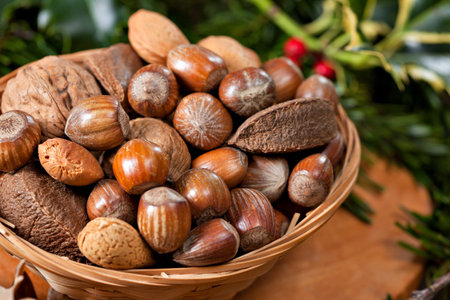 Various Christmas nuts in basket with green twigs decoration