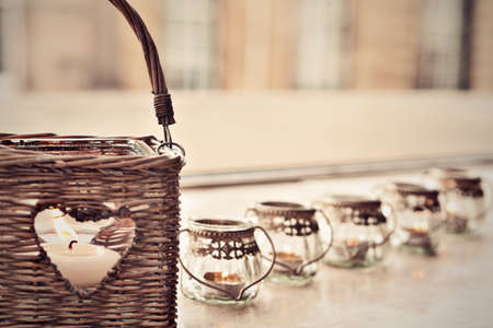 Basket with heart shape hole and burning candle insideの写真素材