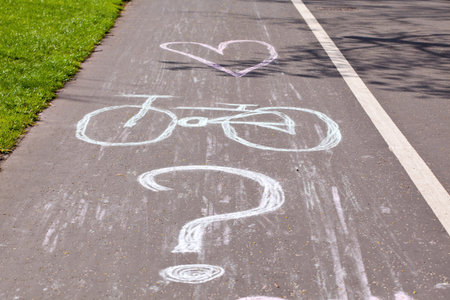 Bicycle symbol drawed with chalk on city cycling route laneの写真素材