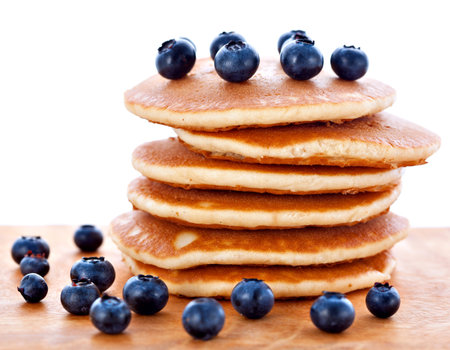 Stack pile of fresh pancakes with blueberries for breakfast on wooden board