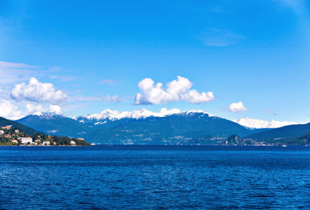 View over Lake Maggiore and Swiss Alps mountains from Italian side in Northern Italy.