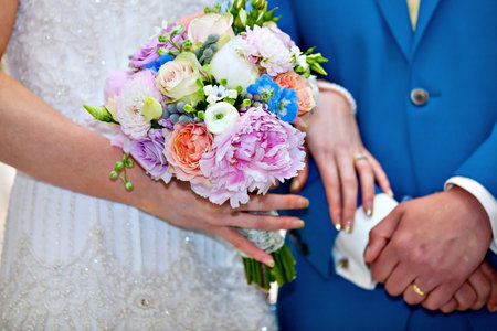 bride and groom holding hands on wedding ceremony