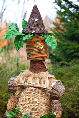 Creative straw scarecrow in a countryside gardenの写真素材