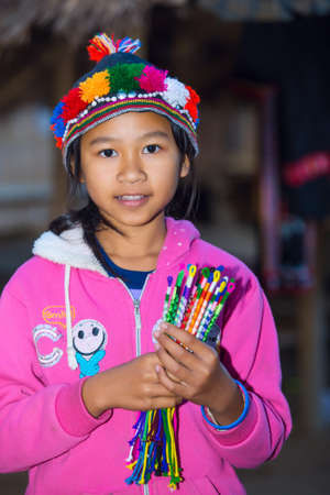 CHIANG RAI, THAILAND - JANUARY 2015: Karen tribal girl selling souvenirs near Mae Hong Son, Thailand, Chiang Rai. Padaung long neck hill tribe village, refugee community originate from neighboring Myanmar.のeditorial素材
