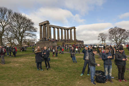 EDINBURGH-SCOTLAND, UK- MARCH 20 : Crowd gathered on Calton hill to witness unique phenomenon of the sun eclipse event on March 20, 2015.のeditorial素材