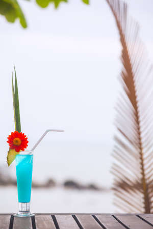 Blue Lagoon cocktail on the table at tropical beachの写真素材