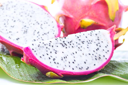 Dragon fruit on banana leaf against white backgroundの写真素材