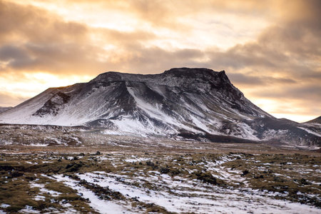Snowy Icelandic mountains with dramatic cloudy sky - amazingly peaceful landscape of Iceland.の写真素材