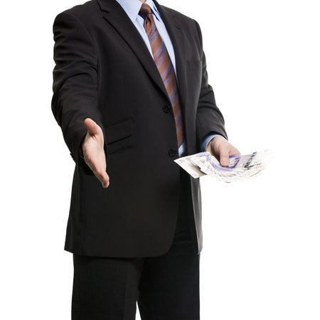 Some unrecognizable Businessman in dark suit shows a Spread of 20 British Pounds Sterling banknotes...