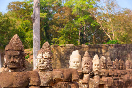 Statues of ancient khmer warrior heads carry giant snake decorating bridge to Bayon at Angkor Wat complex, Siem Reap, Cambodia.の写真素材