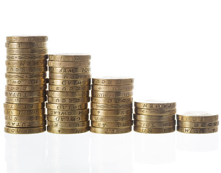 Columns of British Pound Sterling coins in decreasing heights, symbolising steep economic losses and...