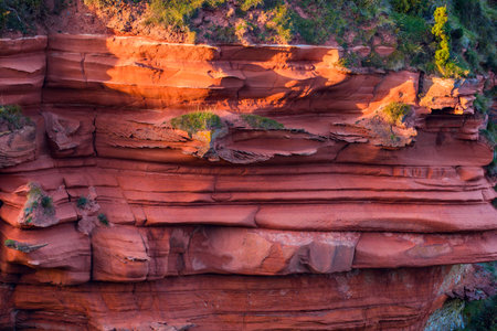Red layered cliffs of Scotland's South-East coast at Scottish borders.