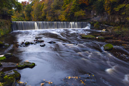 River Almond with waterfall at autumn time, Edinburgh, Scotlandの写真素材