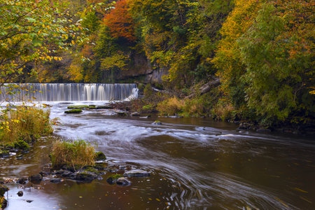 River Almond with waterfall at autumn time, Edinburgh, Scotlandの写真素材
