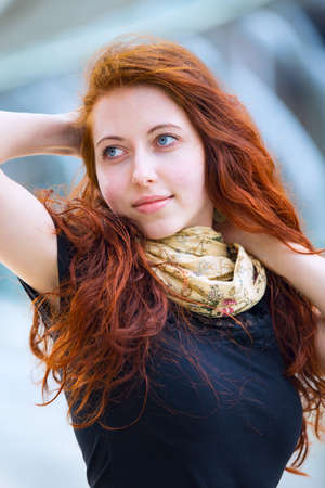 Portrait of young European girl with long messy ginger hair.の写真素材