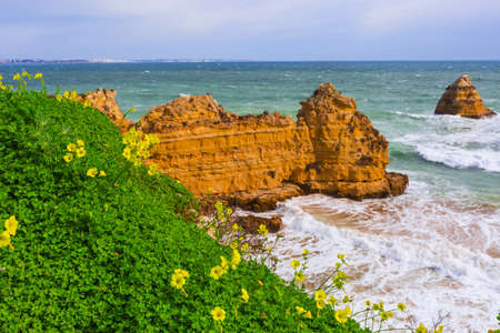 Rocky cliffs of Praia Dona Ana at Lagos, Portugal.の写真素材