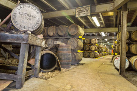 ISLAY, SCOTLAND - SEPT 15 2017 : Old wooden barrels and casks at Lafroaig whisky distillery warehouse established in 1815.のeditorial素材