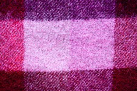 Close up of traditional Scottish woolen tartan fabric. Checkered cashmere plaid.