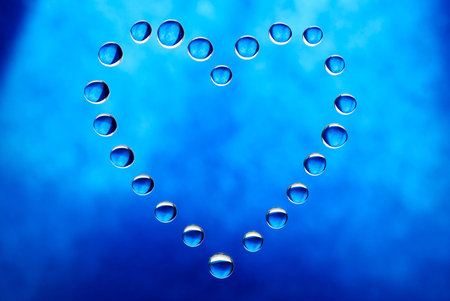 Blue heart shape made of water dropletsの写真素材