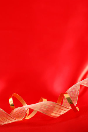 Red silk and golden ribbons backgroundの写真素材