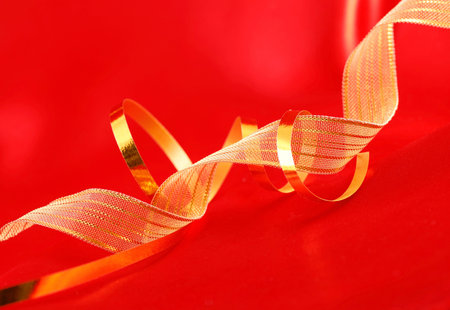 Red silk and golden ribbons backgroundの写真素材