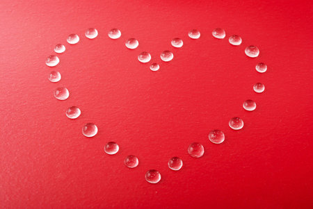 Red heart shape made of water droplets